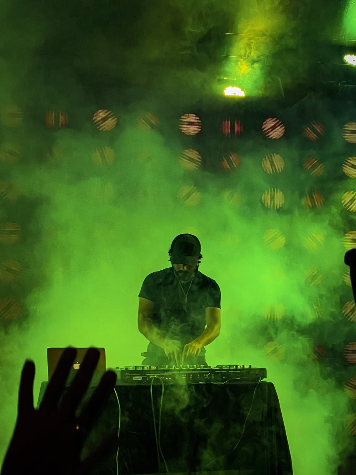 TOSHI performing through green stage haze